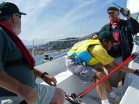 Photo 10.	Paul Borg and Don Scott in practice races for the 2005 Homerus Championships.  Umpire George Chapman (GBR) with two-way radio.